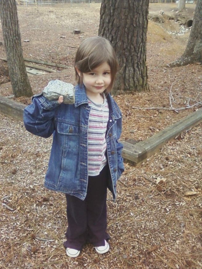 Hope, wearing Mommy's jacket, worked on making a house out of sticks