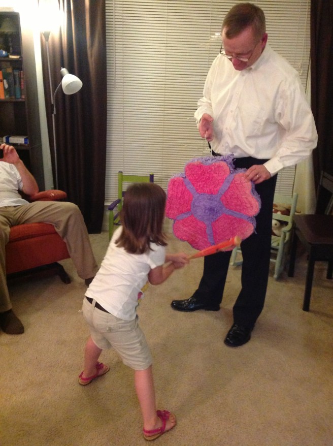 And ladies and gentleman, it's piñata time! (Ok, the girls actually beat on it for an hour in the afternoon. Then beat on it for awhile in the evening; Daddy had to finish it off. = )