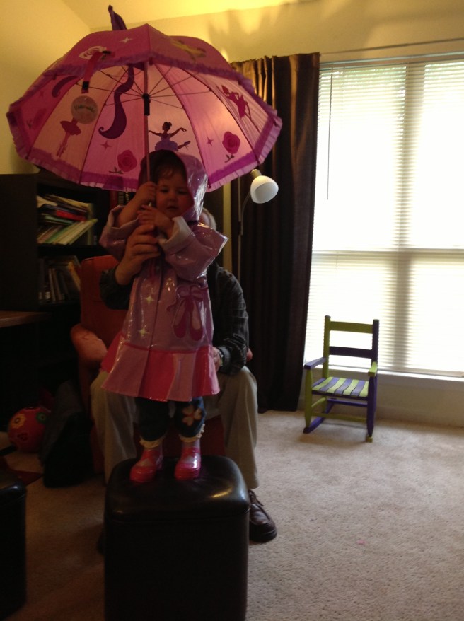 The complete ensemble: raincoat, boots, umbrella.
