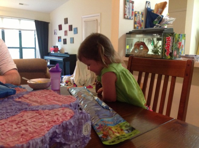 Birthday presents from Dad, Mom, and sisters at lunch. A pin-y-ata and kite in the mix!