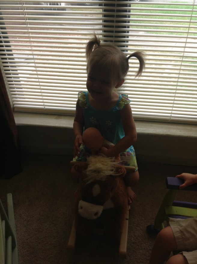 A little dark, but I love that she was giving her baby a ride on the horse.