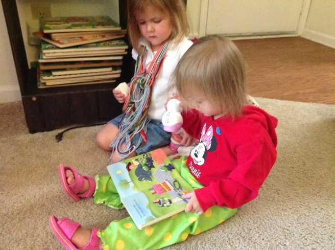 Gracie and Mckayla love sitting next to each to "read." Mckayla is sporting her "does my mom ever do laundry" outfit. 